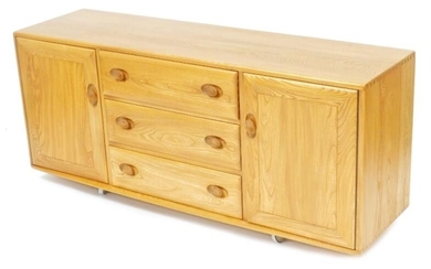 An Ercol light elm sideboard, with three central drawers...