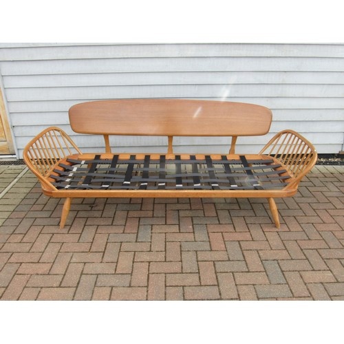 An Ercol light elm sofa "Day Bed" with plank back. No seat p...