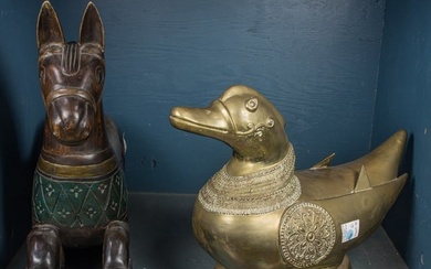 An Indian brass duck and a polychrome carved wood rocking horse