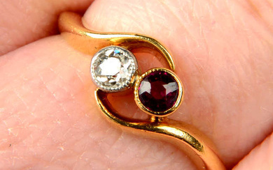 An early 20th century 18ct gold old-cut diamond and ruby two-stone crossover ring.