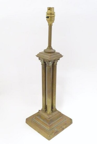 An early 20thC brass table lamp formed as a Corinthian