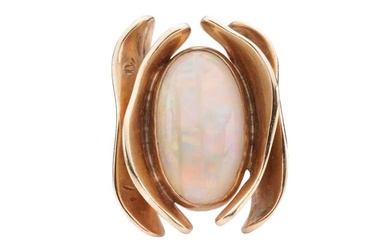 An opal dress ring of stylised design, featuring a bezel set precious opal, measuring approximately