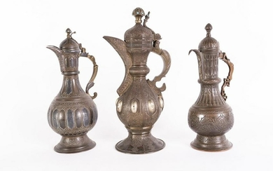 Arte Islamica Three metal coffee jugs engraved with