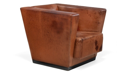 Axel Einar Hjorth: “Lido”. Sculptural easy chair with black lacquered birch base. Sides, seat and back upholstered with patinated reddish brown leather.