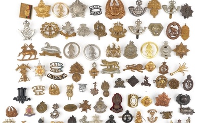 Collection of military interest cap badges and buttons inclu...