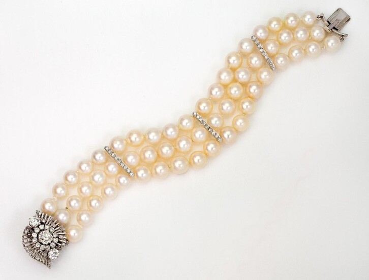 Cultured pearl bracelet, composed of three rows of uniform cultured pearls total fifty seven cultured pearls each of approximately 5mm diameter, with three single-cut diamond set dividing bars, to a diamond cluster clasp, approximate weight of...