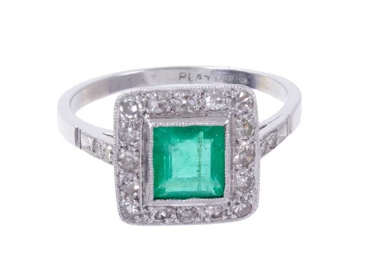 Emerald and diamond cluster ring with a central square step cut emerald estimated to weigh approximately 0.85cts surrounded by a border of single cut diamonds in platinum millegrain setting with di...