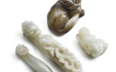 Four small Chinese carvings of greenish and brownish jade in the form of a Foo-dog, man on frog as well as larger and smaller belt buckles. L. 4–10 cm. (4)