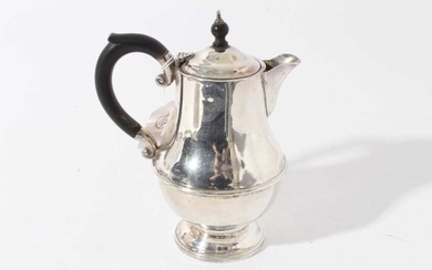 George V silver hot water pot of baluster form with ebony finial and loop handle (Birmingham 1931), maker Marson & Jones, all at 11.8ozs, 18.5cm in height