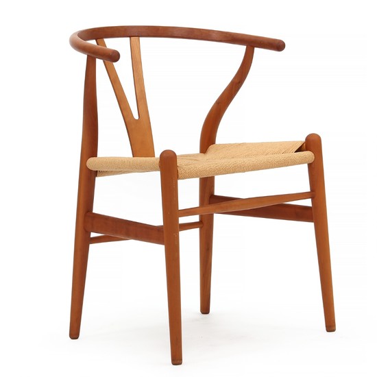 Hans J. Wegner: “Wishbone chair”. Armchair of cherry wood, seat with woven papercord. Manufactured by Carl Hansen & Søn.