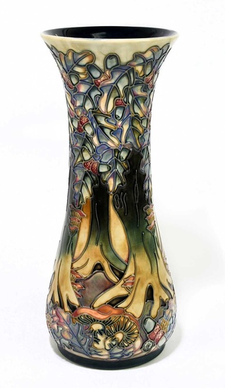 MOORCROFT; a tall vase decorated with a woodland scene, impressed...