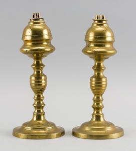 PAIR OF BRASS WHALE OIL LAMPS ATTRIBUTED TO WILLIAM H. WEBB With banded lemon-form fonts, ring- and beehive-turned shafts and steppe...