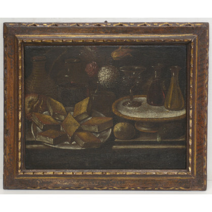Scuola spagnola del secolo XVII "Vetri, vivande e fiori" olio su tela (cm 46x60). In cornice antica (difetti e restauri)