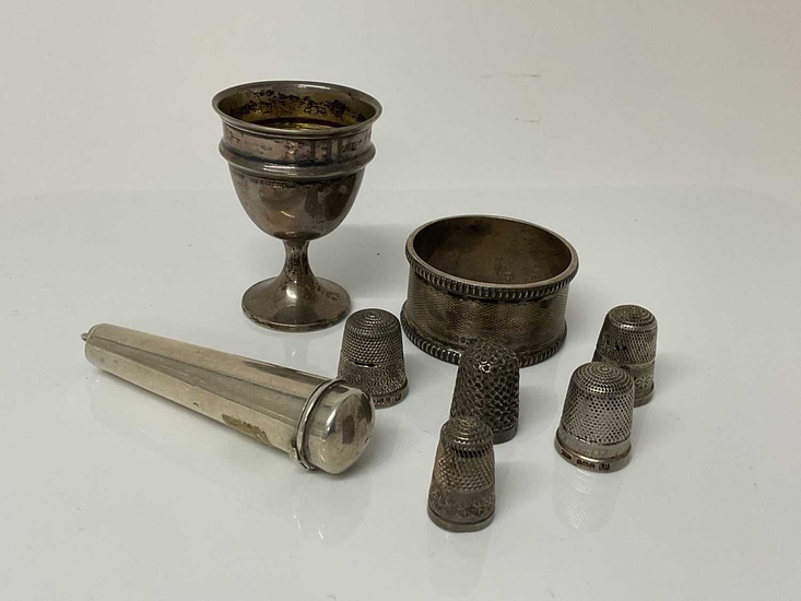 Small group of Victorian and later silver items to include a cheroot holder, (Birmingham 1899), a silver egg cup (Birmingham 1939), silver napkin ring (Birmingham 1936) and five silver thimbles (va...