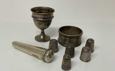 Small group of Victorian and later silver items to include a cheroot holder, (Birmingham 1899), a silver egg cup (Birmingham 1939), silver napkin ring (Birmingham 1936) and five silver thimbles (va...