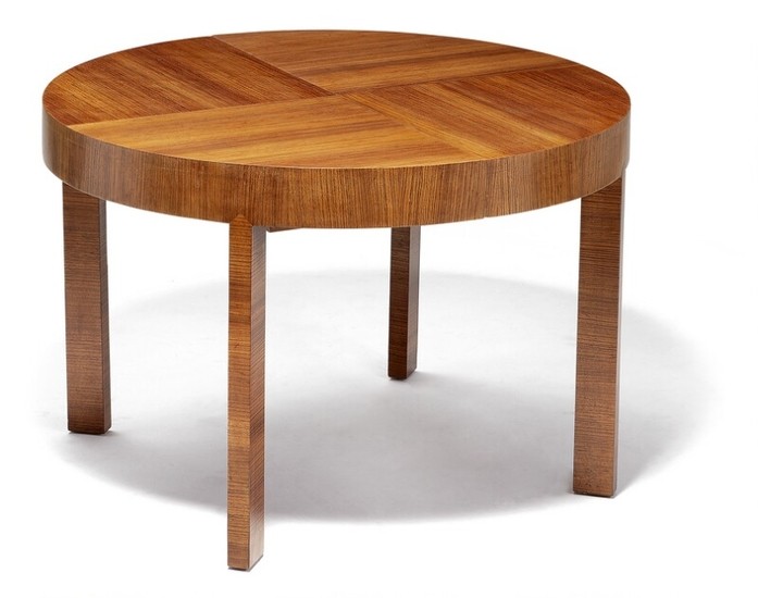 Torkov: A unique Zebrano dining table mounted on rectangular legs. Circular top with extension and three pine leaves.
