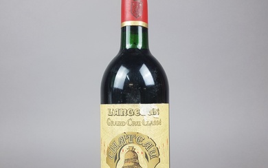 Une bouteille de Château l'Angélus, Saint Emilion, 1986 - étiquette abimée
