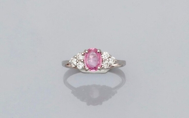 White gold ring, 750 MM, set with an oval pink sapphire weighing 0.86 carat between six brilliants, size: 53, weight: 2.5gr. gross.