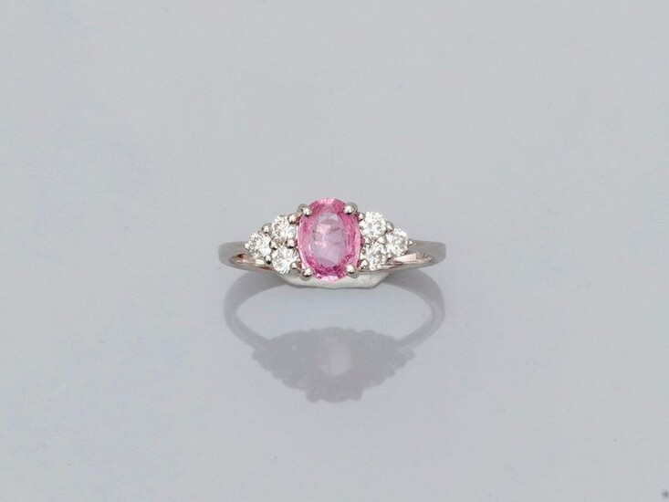 White gold ring, 750 MM, set with an oval pink sapphire weighing 0.86 carat between six brilliants, size: 53, weight: 2.5gr. gross.