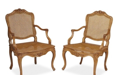 A pair of Louis XV caned beechwood fauteuils à...