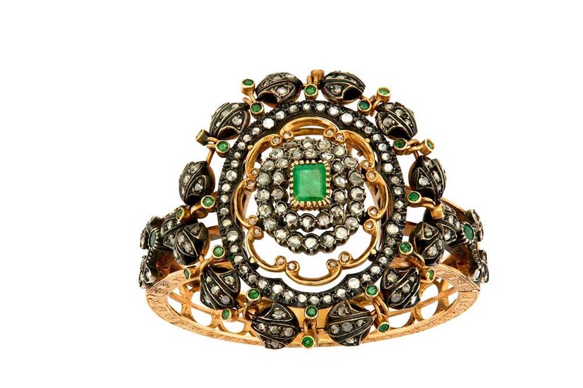An emerald and diamond bangle, circa 1900 The hinged...