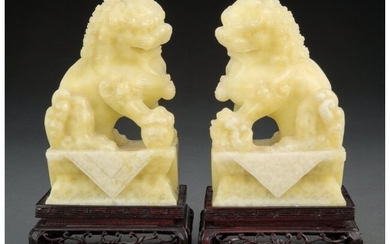 25047: A Pair of Chinese Carved Hardstone Lions on Stan