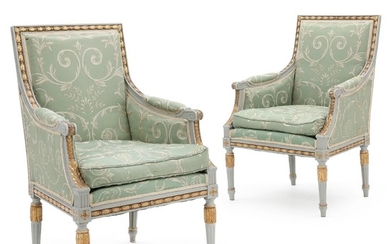 A pair of painted and gilt Swedish armchairs. Gustavian style, early 20th century. (2).