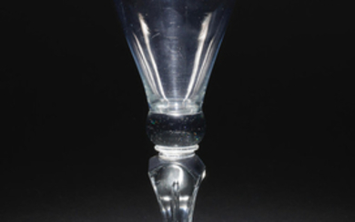 A rare moulded stem baluster wine glass, circa 1715