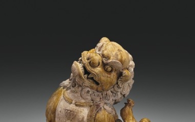 A VERY RARE AND SUPERBLY MODELED LARGE AMBER-GLAZED POTTERY FIGURE OF A SEATED LION, SONG-JIN DYNASTY (AD 960-1234)