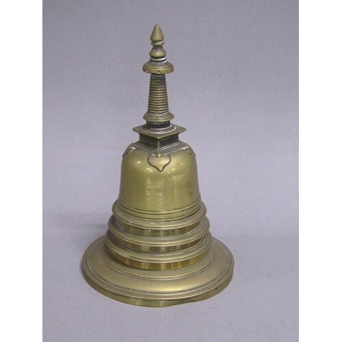 A 19c brass stepped single bottle ink well with a lift off d...