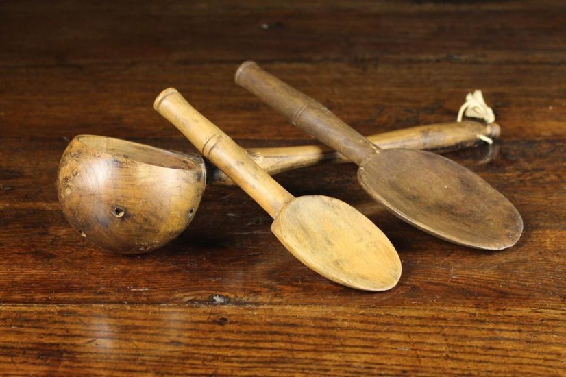 A 19th Century Treen Ladle & Two Treen Spoons. The ladle having a globular bowl pierced with drainin