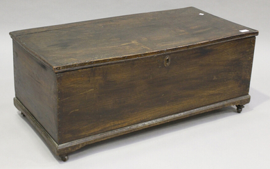 A 19th century stained elm trunk, the interior later lined in paper, height 38cm, width 92cm, depth