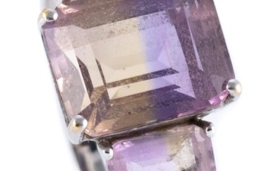 A 9CT WHITE GOLD AMETRINE RING; set with 3 emerald cut ametrines totalling approx. 4.00ct with a small amethyst set at each shoulder...
