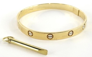A 9ct gold bangle, with etched design, makers stamp...