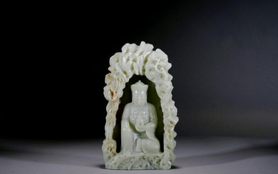 A CHINESE CELADON JADE CARVED BUDDHA IN GROTTO
