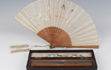 A Chinese Canton export sandalwood and silk folding fan, late 19th century, the guards carved with f