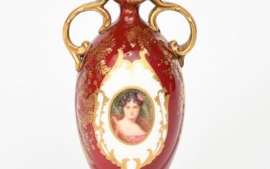 A Doulton Burslem porcelain vase, slender, shouldered form with applied scroll handles, painted in colours with a portrait of a maiden, roundel inside gilt frame, on a red ground, printed factory mark, 22cm. high