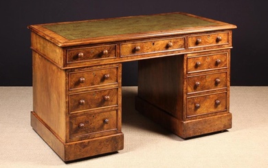 A Fine Victorian Figured Walnut Pedestal Desk. The rectangular top with moulded edge and a tooled gr