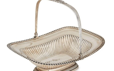 A George III silver cake basket, London, c.1813, possibly William Kingdon, of rounded rectangular form with lobed body to plain rim and reeded swing handle, the body raised on a lobed rectangular foot, 10.5cm high, 31.5cm long, approx. weight 34oz