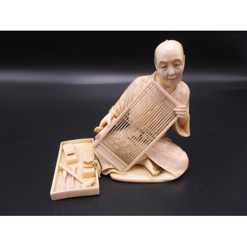 A Japanese Meiji period ivory okimono, modelled as an artisa...