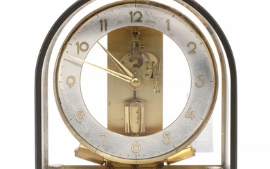 A Junghans Ato magnetic pendant skeleton table clock made of brass under...