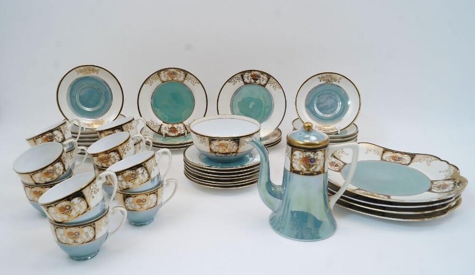 A Noritake coffee service, first half 20th century, red backstamp with 'Komaru' mark, accented Noritake and Made in Japan in handwritten logo, designed with a turquoise ground and gilt border to rim with cobalt blue panel containing an urn of...