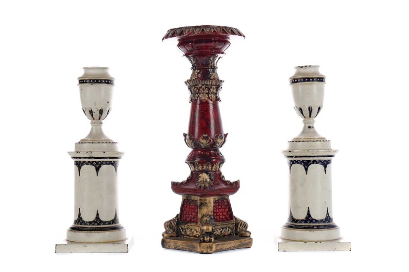 A PAIR OF CAST METAL CANDLESTICKS, ALONG WITH ANOTHER
