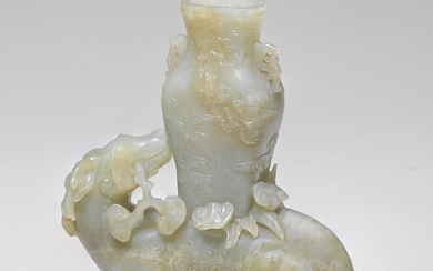 A PALE GREEN AND RUSSET JADE DEER AND VASE GROUP...