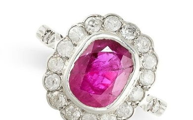 A RUBY AND DIAMOND CLUSTER RING set with a cushion cut