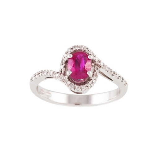 A RUBY AND DIAMOND CLUSTER RING, the oval ruby to cross over...