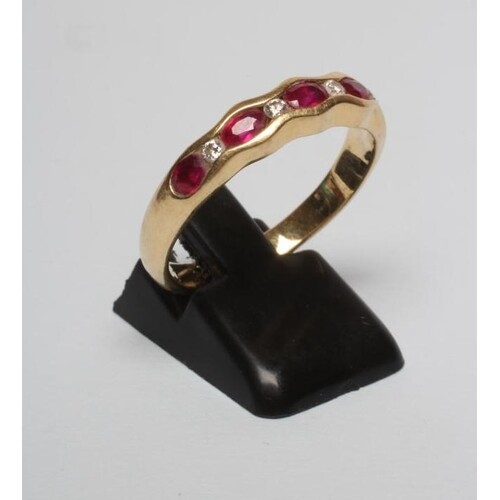 A RUBY HALF HOOP RING, the five oval facet cut stones horizo...