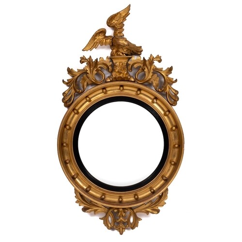 A Regency carved giltwood and gesso circular convex mirror:,...