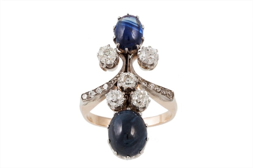 A SAPPHIRE AND DIAMOND FINGERLINE RING, set with two cabacho...