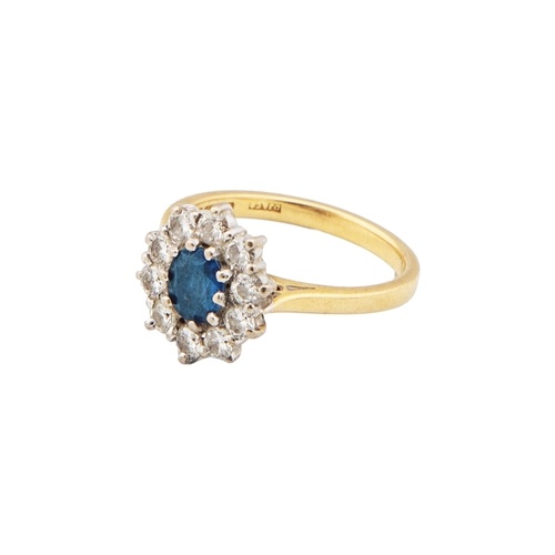 A Sapphire and diamond cluster ring The oval mixed cut sapph...